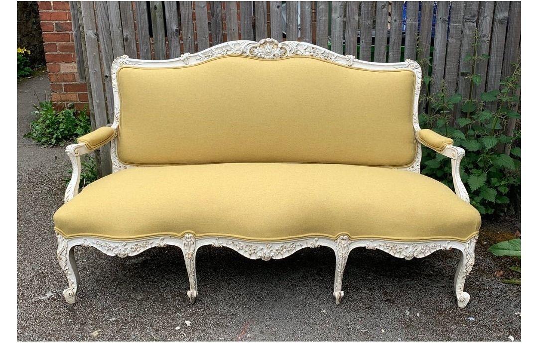 Carved French-style settee re-covered in yellow