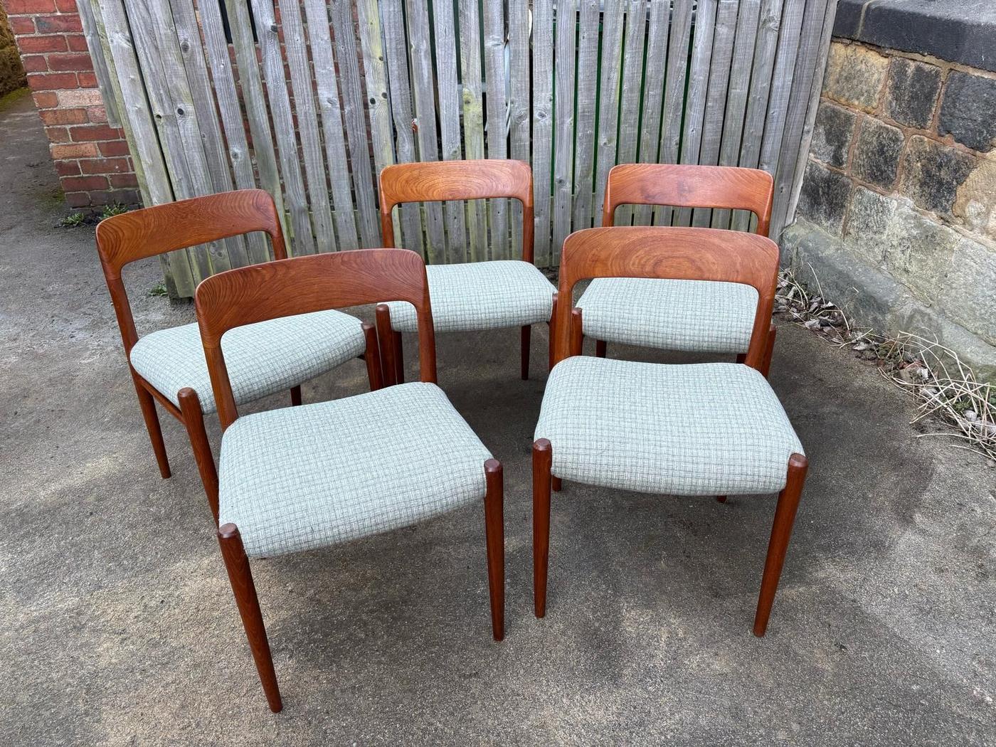 Four teak dining chairs with pale green seats