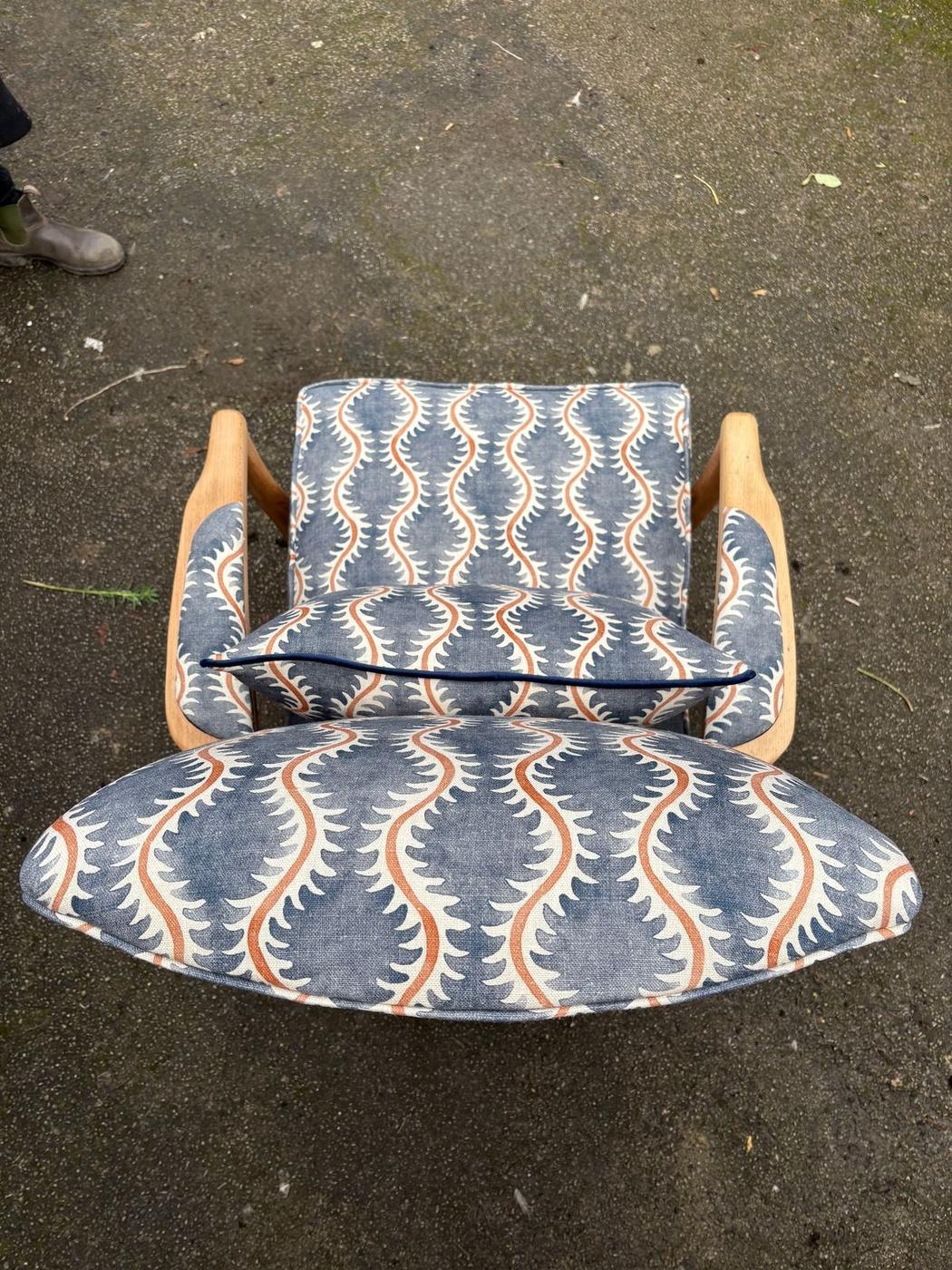 Mid-century armchair and footstool in a blue and orange wave print