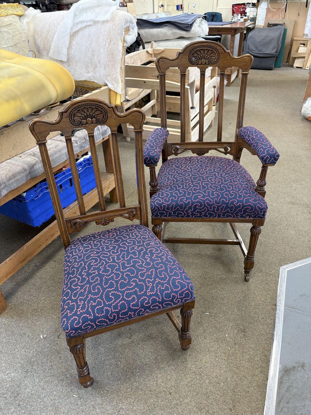 Two carved Victorian chairs re-covered in navy patterned fabric