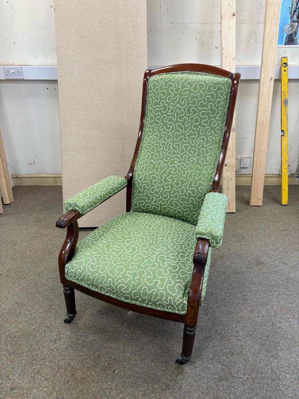Victorian armchair in a green patterned fabric