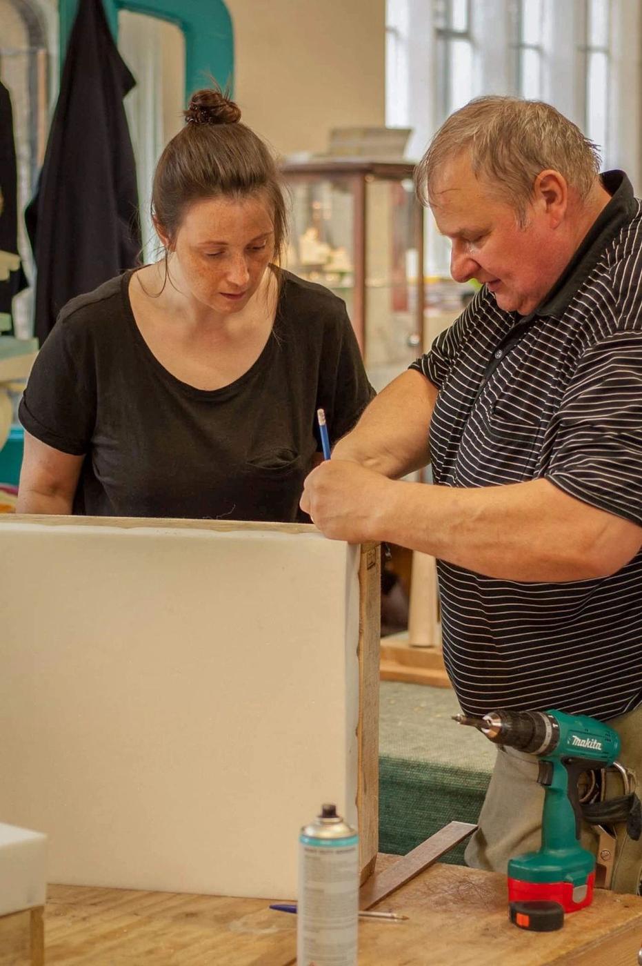A student and tutor working on a frame together in the workshop