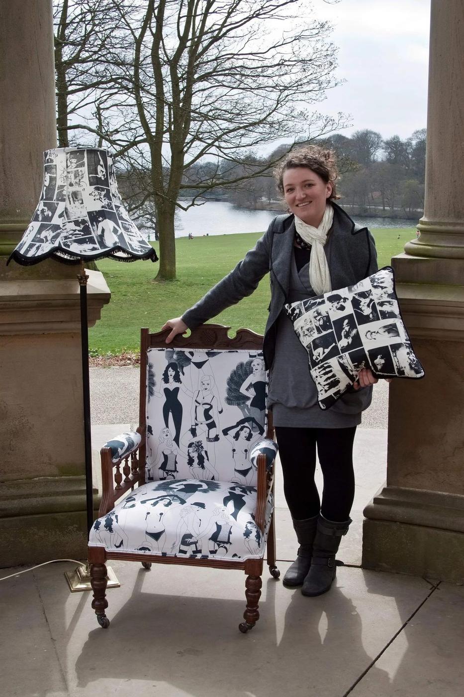Emily with a finished armchair in a black and white print