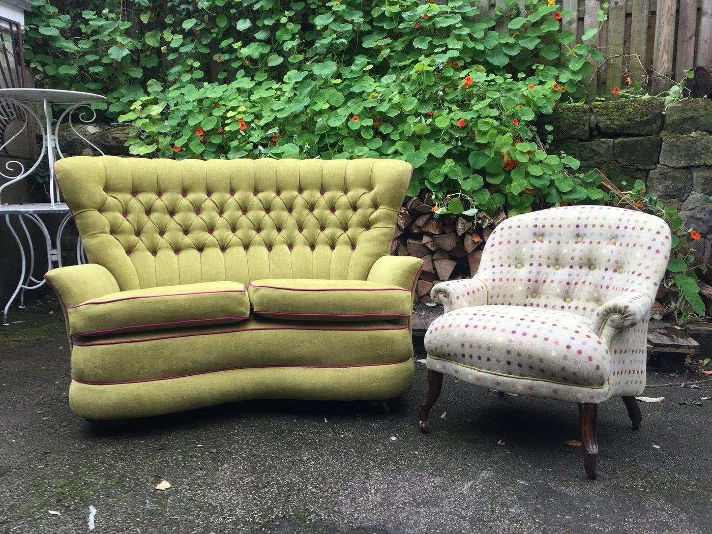 Lime buttoned sofa and a spotted armchair in a garden