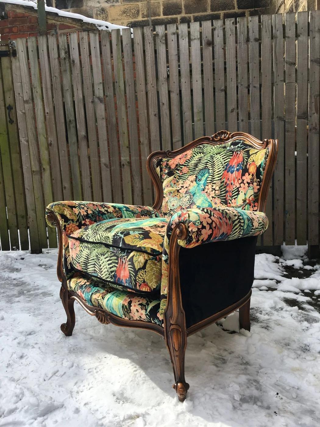 Carved armchair in a tropical print, photographed in the snow