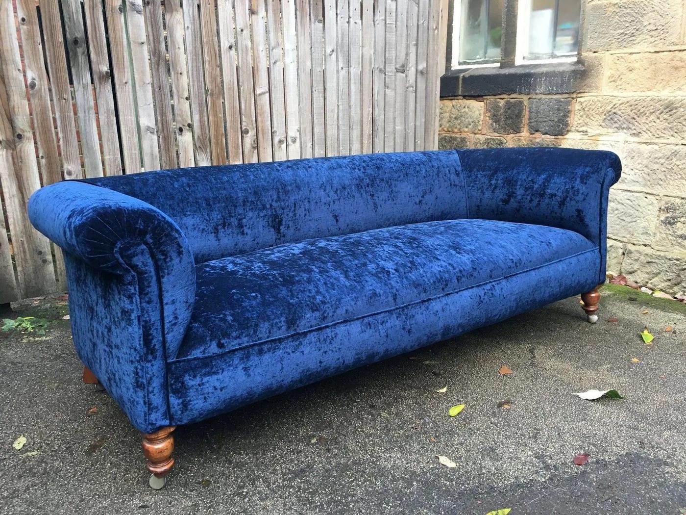 Blue velvet sofa with turned legs